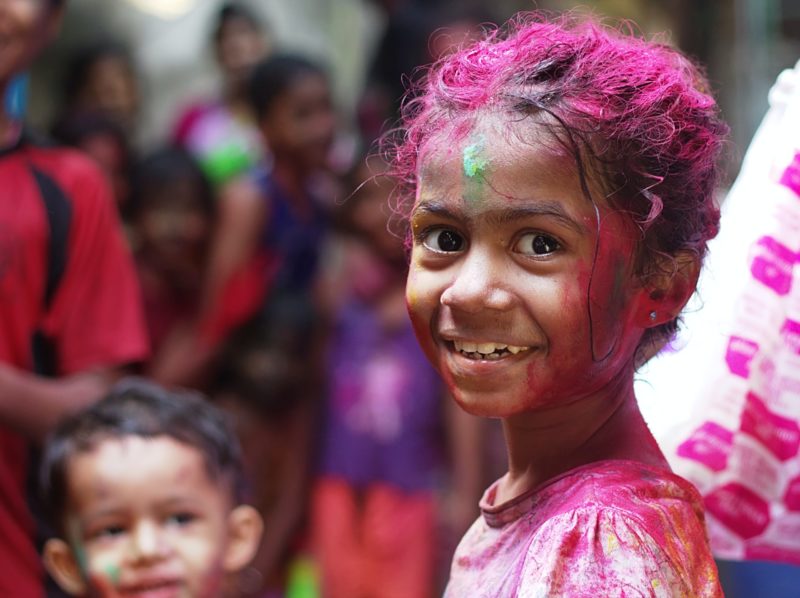 Young darker skinned girl with purple-dyed hair and shirt